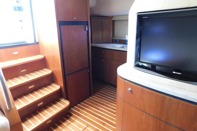 Slide: The Image of Interior of 2009 Tiara Yachts 4300 Sovran with wooden stairs and TV. - 51