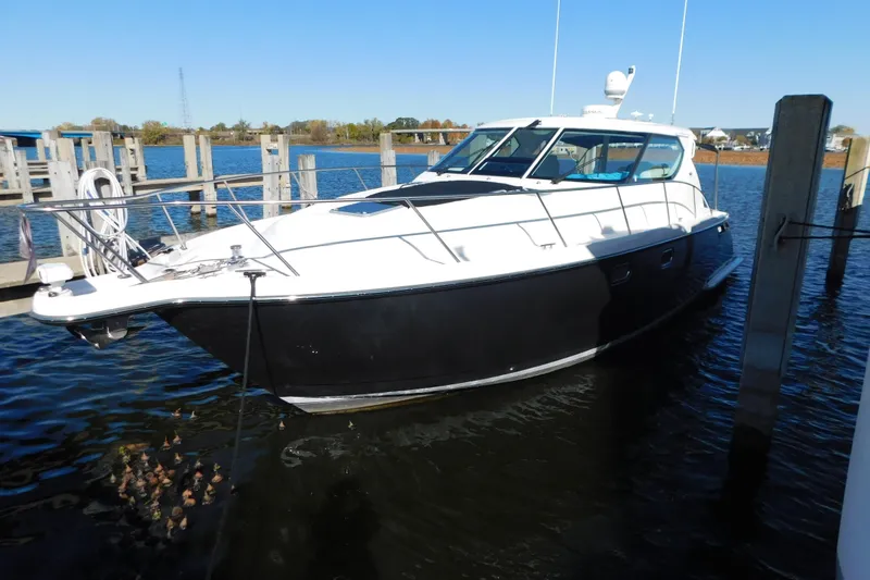 Slide: The Image of 2009 Tiara Yachts 4300 Sovran docked in a marina on a sunny day. - 56