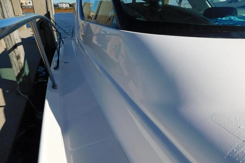 Slide: The Image of 2009 Tiara Yachts 4300 Sovran docked, showcasing sleek white exterior and railing. - 57