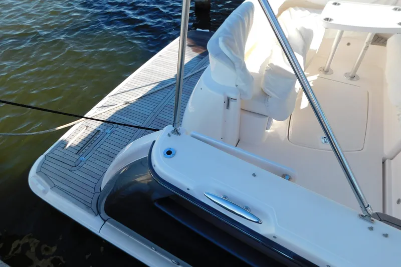 Slide: The Image of 2009 Tiara Yachts 4300 Sovran deck with seating and railing, docked on calm water. - 59