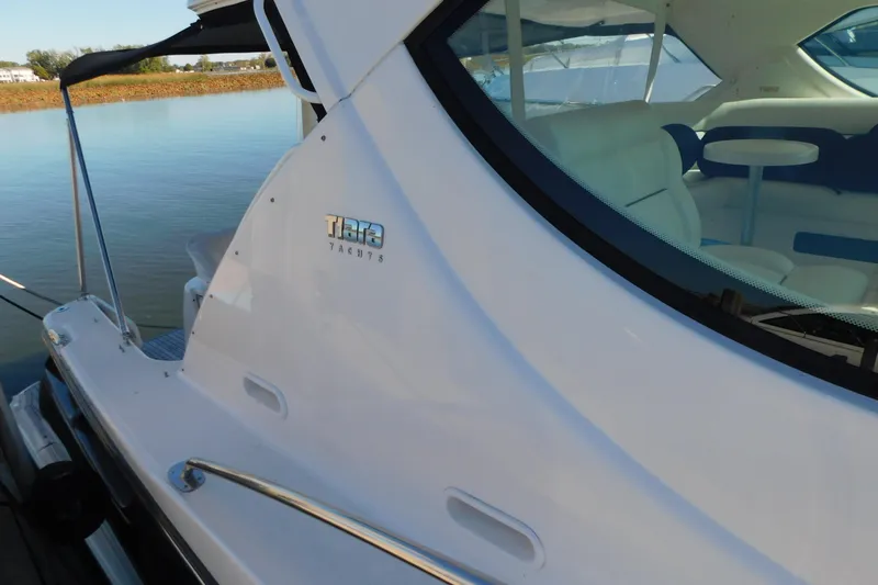 Slide: The Image of 2009 Tiara Yachts 4300 Sovran, docked with visible interior seating and table. - 6