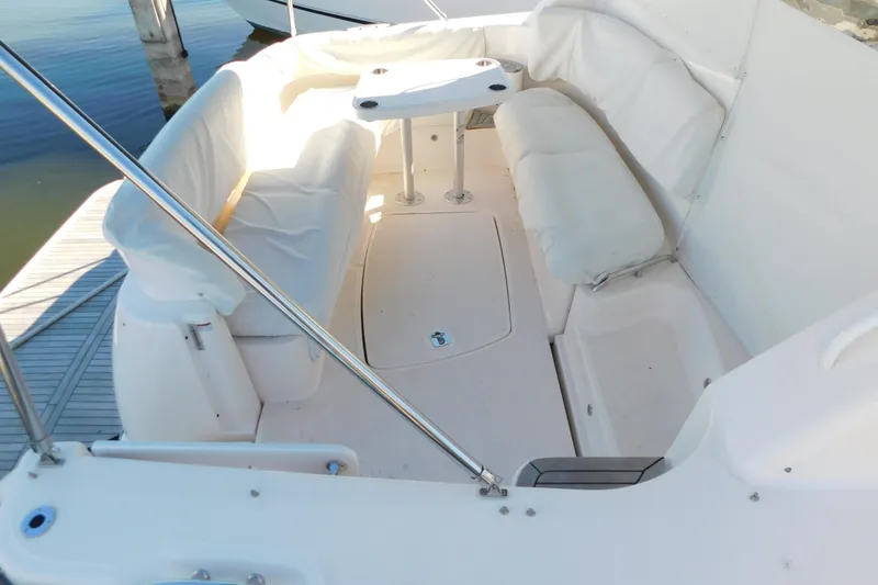Slide: The Image of 2009 Tiara Yachts 4300 Sovran cockpit with white seating and table. - 7