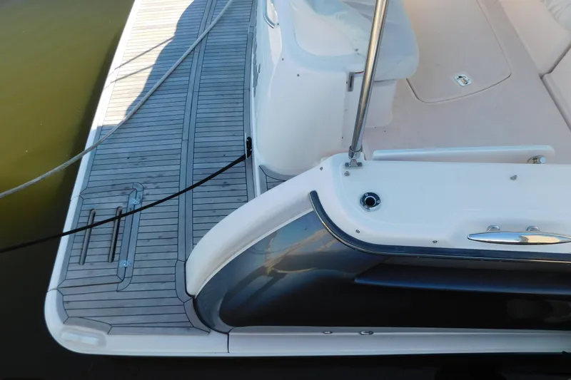 Slide: The Image of 2009 Tiara Yachts 4300 Sovran, deck view with teak flooring and seating area. - 9