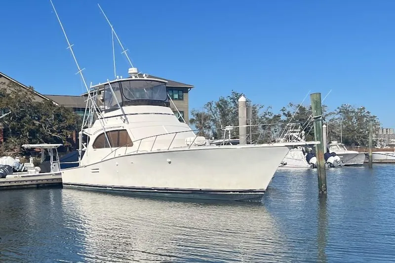 The Image of 1988 Post 46 ll yacht docked in a marina under clear blue skies. - 0