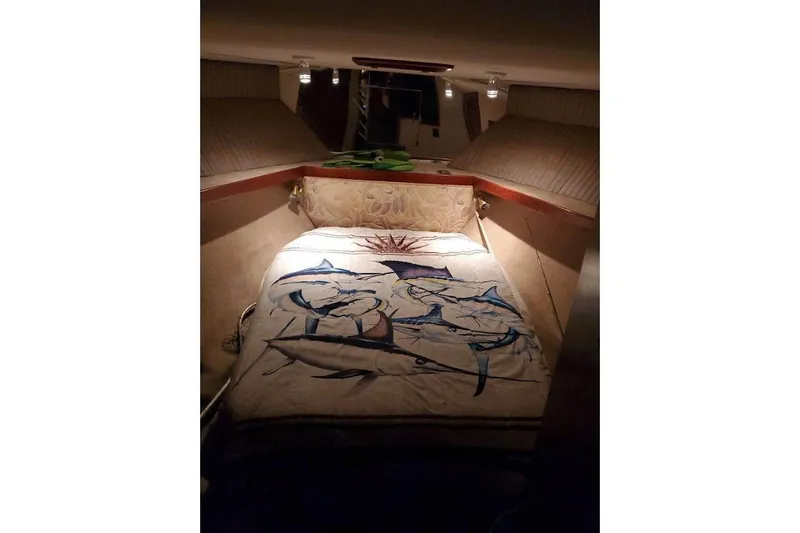 Slide: The Image of Cozy cabin interior of 1988 Post 46 ll boat with marine-themed bedding. - 10