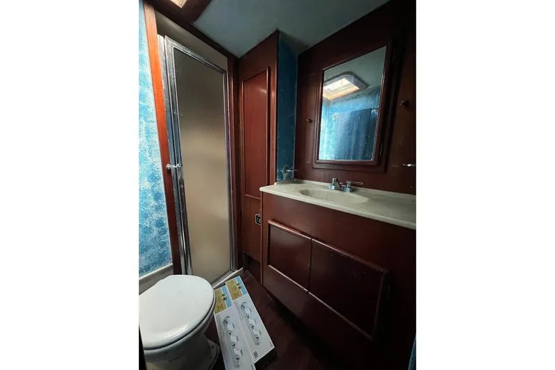 Slide: The Image of Compact bathroom in a 1988 Post 46 ll boat with shower and vanity. - 11
