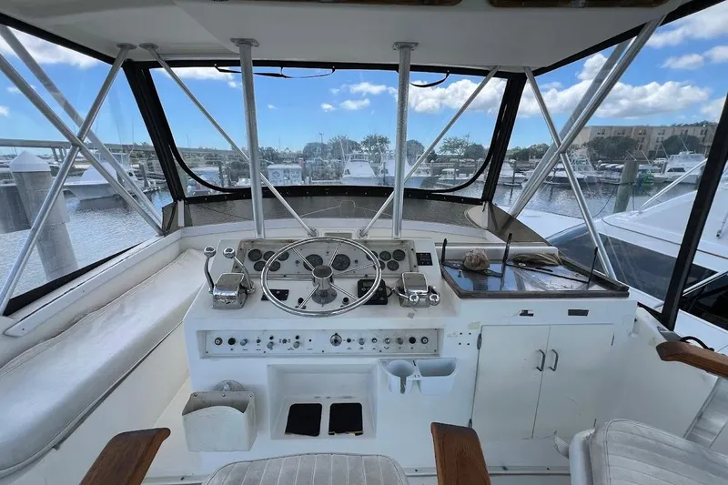 Slide: The Image of Helm of 1988 Post 46 ll yacht with steering wheel and control panel, docked at marina. - 14