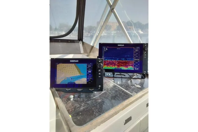 Slide: The Image of Simrad navigation and sonar displays on 1988 Post 46 ll boat dashboard. - 15