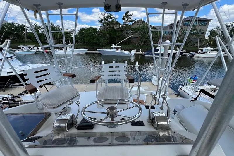 Slide: The Image of Helm of 1988 Post 46 ll yacht with marina view and boats docked nearby. - 16