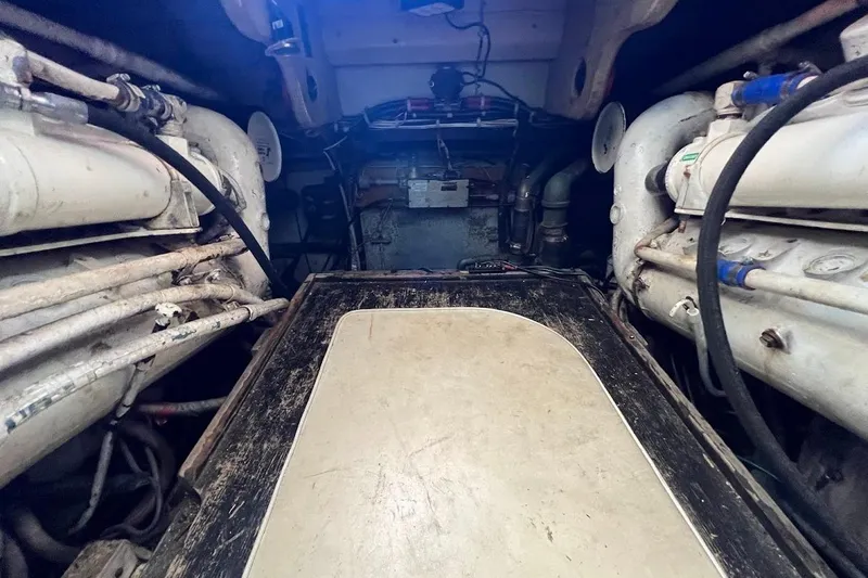 Slide: The Image of Engine room of a 1988 Post 46 ll boat, showcasing mechanical components and piping. - 17