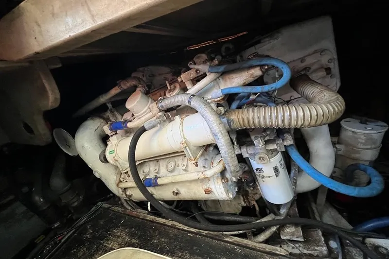 Slide: The Image of Engine compartment of a 1988 Post 46 ll boat, featuring hoses and mechanical components. - 19