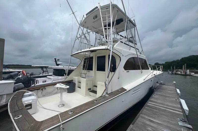 Slide: The Image of 1988 Post 46 ll yacht docked at marina under cloudy sky. - 24