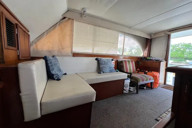 Slide: The Image of Interior of 1988 Post 46 ll boat with seating, cushions, and natural light. - 3