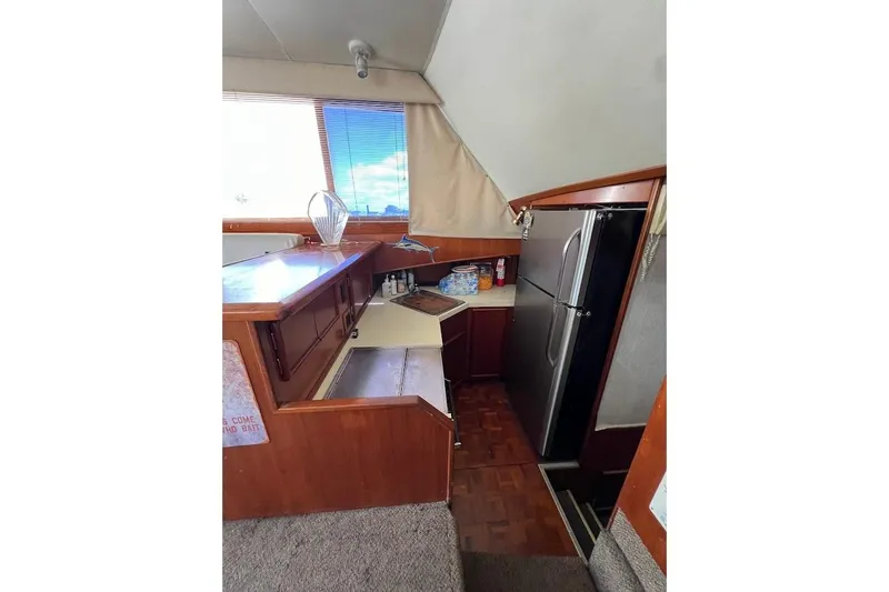 Slide: The Image of 1988 Post 46 ll yacht interior kitchen with wood cabinetry and modern appliances. - 4