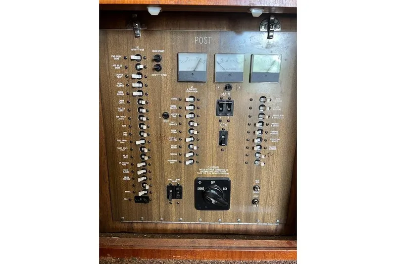 Slide: The Image of Electrical control panel of a 1988 Post 46 ll boat with switches and gauges. - 7
