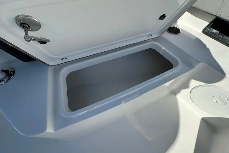 Slide: The Image of 2026 Sea Pro 292 Offshore boat storage compartment with open lid, showcasing interior space. - 10