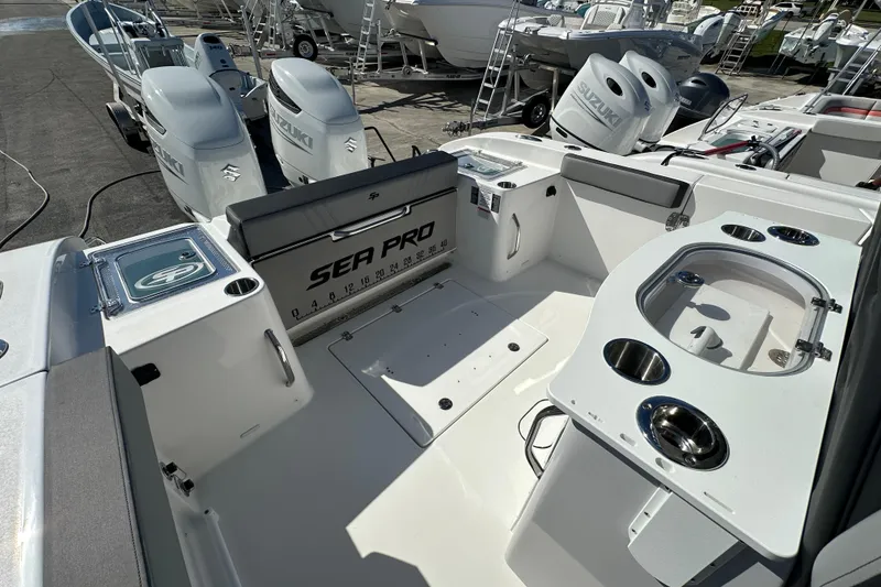 Slide: The Image of 2026 Sea Pro 292 Offshore boat interior with Suzuki engines, featuring fishing amenities and seating. - 14
