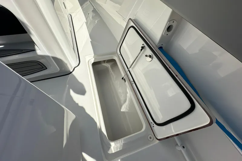 Slide: The Image of 2026 Sea Pro 292 Offshore boat storage compartment with open hatch, showcasing interior space. - 15