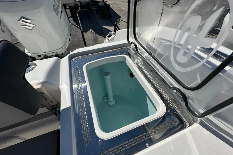 Slide: The Image of 2026 Sea Pro 292 Offshore boat with open livewell and Suzuki outboard motor. - 19