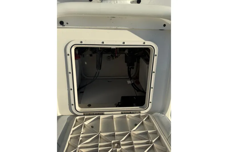 Slide: The Image of 2017 Skeeter SX230 boat storage compartment with visible wiring and equipment. - 10