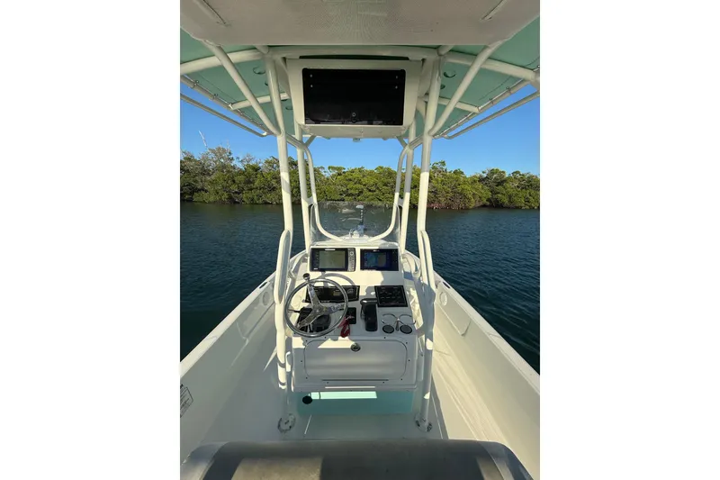 Slide: The Image of 2017 Skeeter SX230 boat interior with steering console, on calm water. - 13