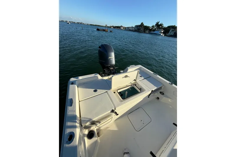 Slide: The Image of 2017 Skeeter SX230 boat with outboard motor on calm water. - 16