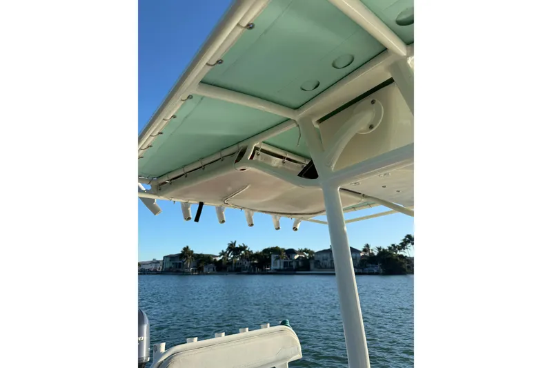 Slide: The Image of 2017 Skeeter SX230 boat canopy with scenic waterfront view. - 23