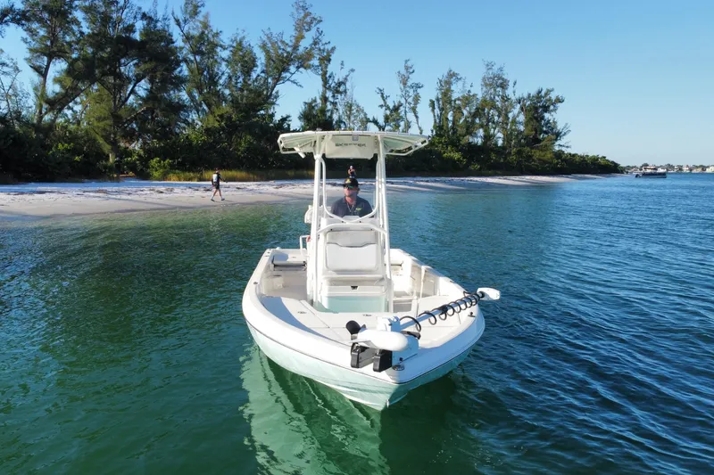 Slide: The Image of 2017 Skeeter SX230 boat cruising on clear blue water. - 5