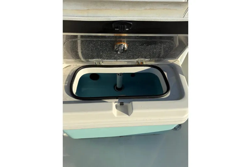 Slide: The Image of Open livewell on 2017 Skeeter SX230 boat, showcasing interior design and functionality. - 9