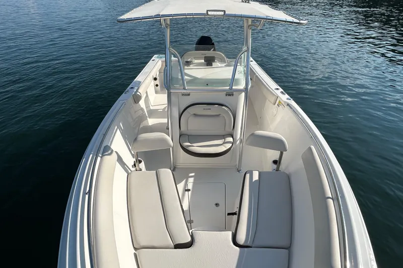 Slide: The Image of 2022 Sailfish 242 CC boat interior with seating, on calm water. - 10