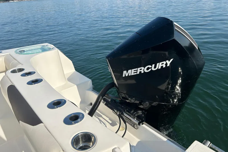 Slide: The Image of 2022 Sailfish 242 CC boat with Mercury outboard engine on calm water. - 11