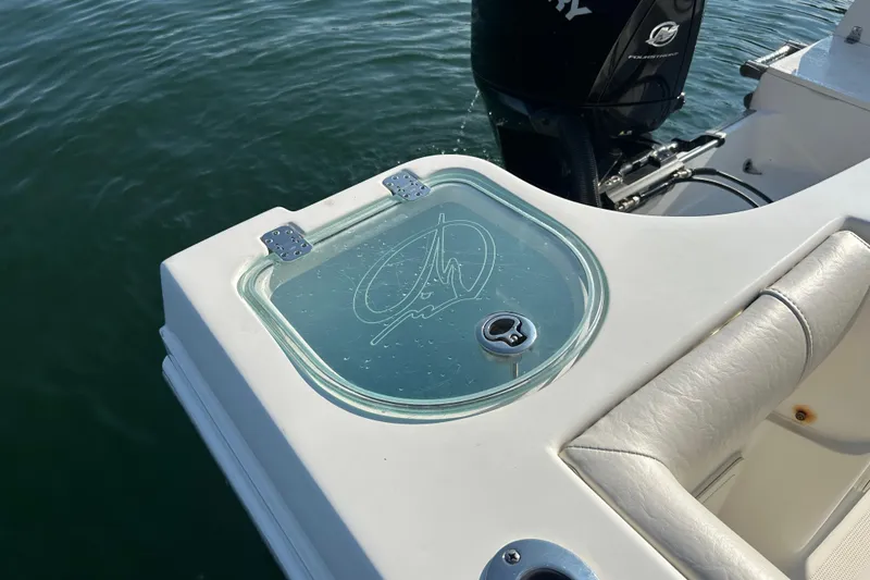 Slide: The Image of 2022 Sailfish 242 CC boat with glass compartment and Mercury engine on water. - 12