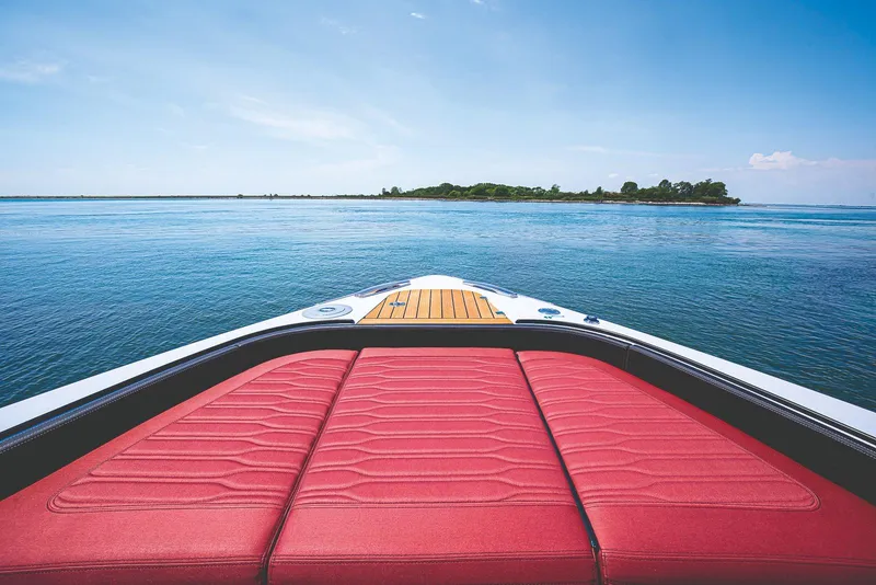 Slide: The Image of Cranchi A46 Luxury Tender 2026 with red seating and teak deck, on water. - 12