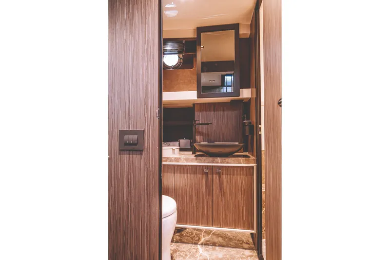 Slide: The Image of Modern bathroom sink on Cranchi A46 Luxury Tender, 2026 model, with sleek black fixtures. - 28