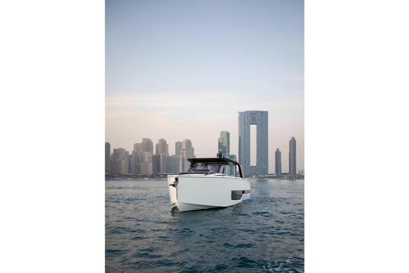 Slide: The Image of 2026 Cranchi A46 Luxury Tender cruising at sunset near city skyline. - 7