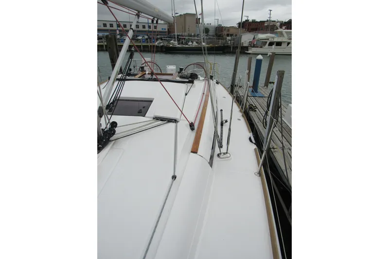 Slide: The Image of 2013 Jenneau Sun Odyssey 379 sailboat docked, showcasing deck and rigging. - 13