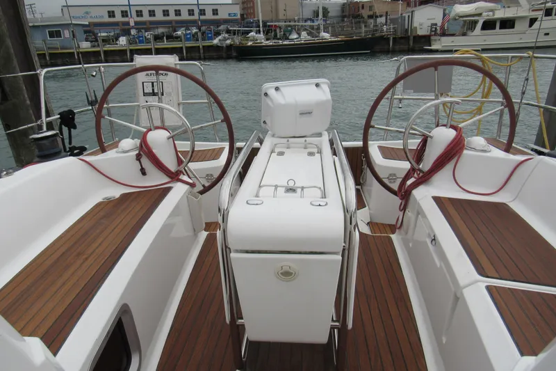 Slide: The Image of 2013 Jenneau Sun Odyssey 379 yacht cockpit with dual steering wheels and teak flooring. - 14