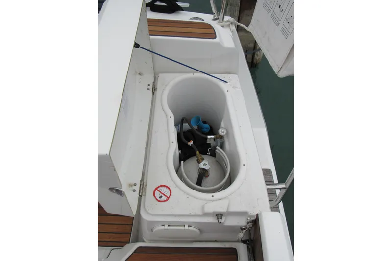 Slide: The Image of Storage compartment on 2013 Jenneau Sun Odyssey 379 sailboat, featuring equipment and hoses. - 17
