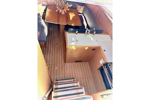 Slide: The Image of Interior of 2013 Jenneau Sun Odyssey 379 sailboat, featuring a cozy dining and kitchen area. - 19