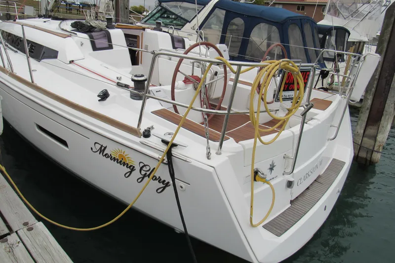 Slide: The Image of 2013 Jenneau Sun Odyssey 379 sailboat docked, named "Morning Glory," with nautical equipment visible. - 2