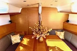 Slide: The Image of 2013 Jenneau Sun Odyssey 379 interior with elegant dining area and floral centerpiece. - 22