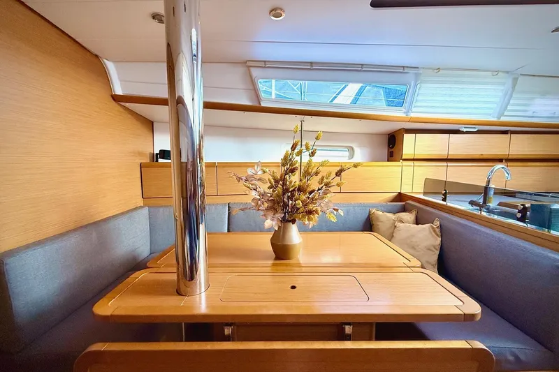 Slide: The Image of Interior of 2013 Jenneau Sun Odyssey 379 yacht with cozy dining area and floral centerpiece. - 24