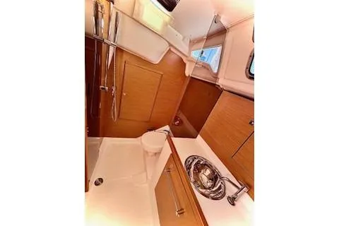Slide: The Image of 2013 Jenneau Sun Odyssey 379 yacht interior bathroom with sink and wooden cabinetry. - 33