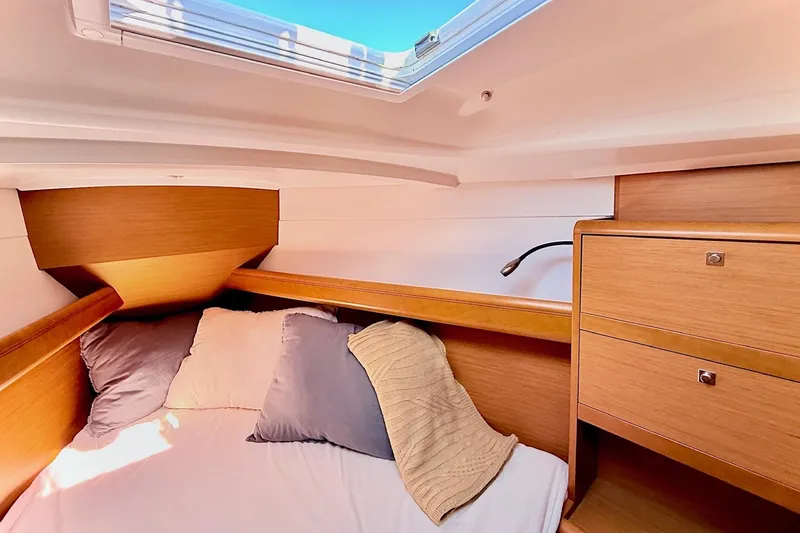 Slide: The Image of Cozy cabin interior of 2013 Jenneau Sun Odyssey 379 sailboat with pillows and wooden cabinetry. - 42
