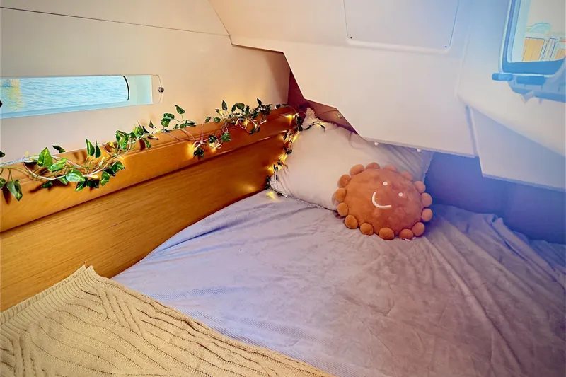 Slide: The Image of Cozy cabin interior of 2013 Jenneau Sun Odyssey 379 with decorative lights and plush pillow. - 45