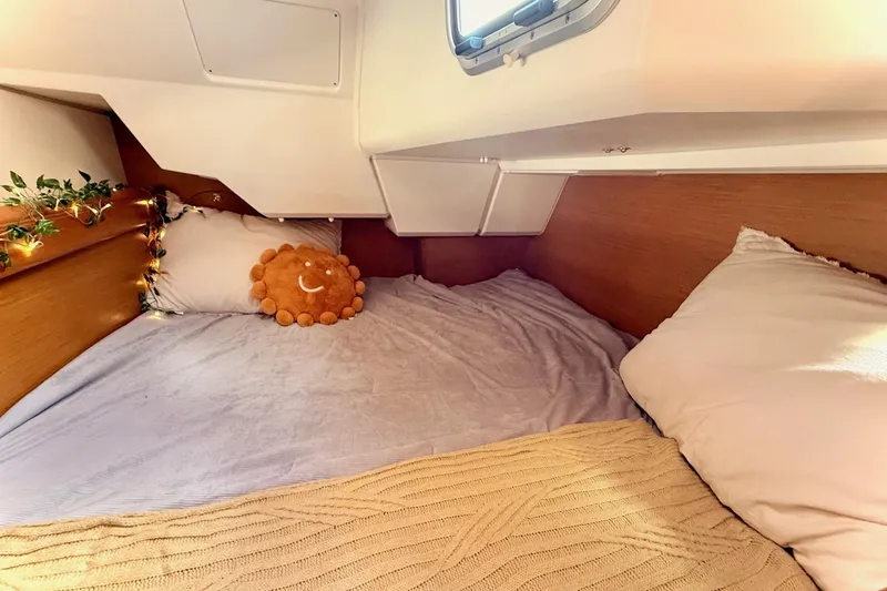 Slide: The Image of Cozy cabin interior of 2013 Jenneau Sun Odyssey 379 with pillows and decorative lights. - 46