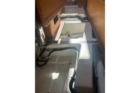 Slide: The Image of 2013 Jenneau Sun Odyssey 379 interior with visible storage compartments and wiring. - 47