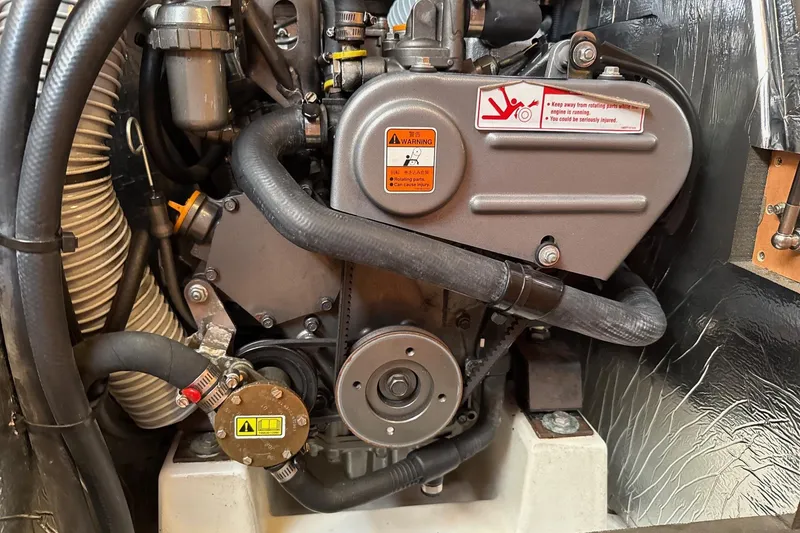 Slide: The Image of Engine compartment of a 2013 Jenneau Sun Odyssey 379 sailboat, showcasing mechanical components. - 49