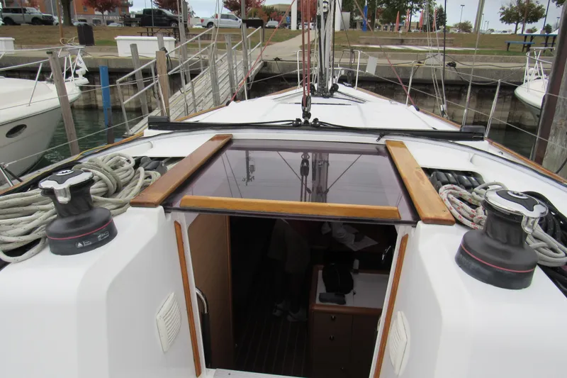 Slide: The Image of 2013 Jenneau Sun Odyssey 379 sailboat deck with ropes and open cabin entrance. - 6