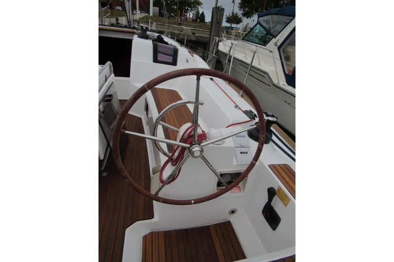 Slide: The Image of Steering wheel of 2013 Jenneau Sun Odyssey 379 sailboat, docked with visible deck details. - 9